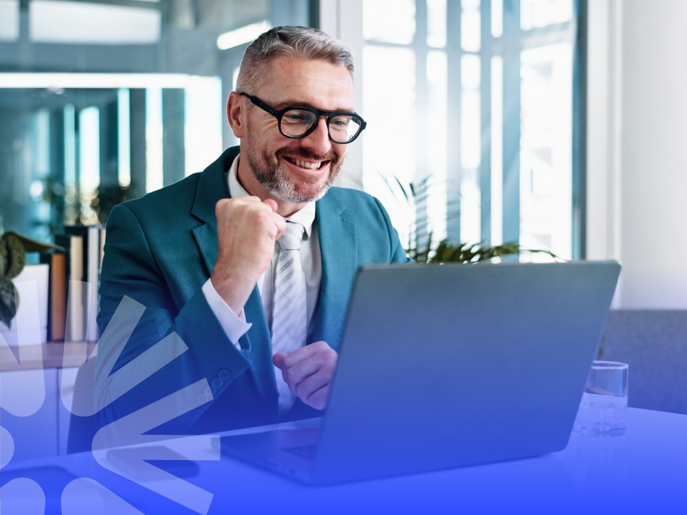 man happy at work desk